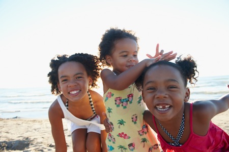 Black girls playing on beach